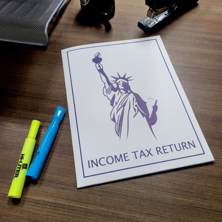 Statue of Liberty income tax return pocket folder with navy blue cover design and two internal pockets